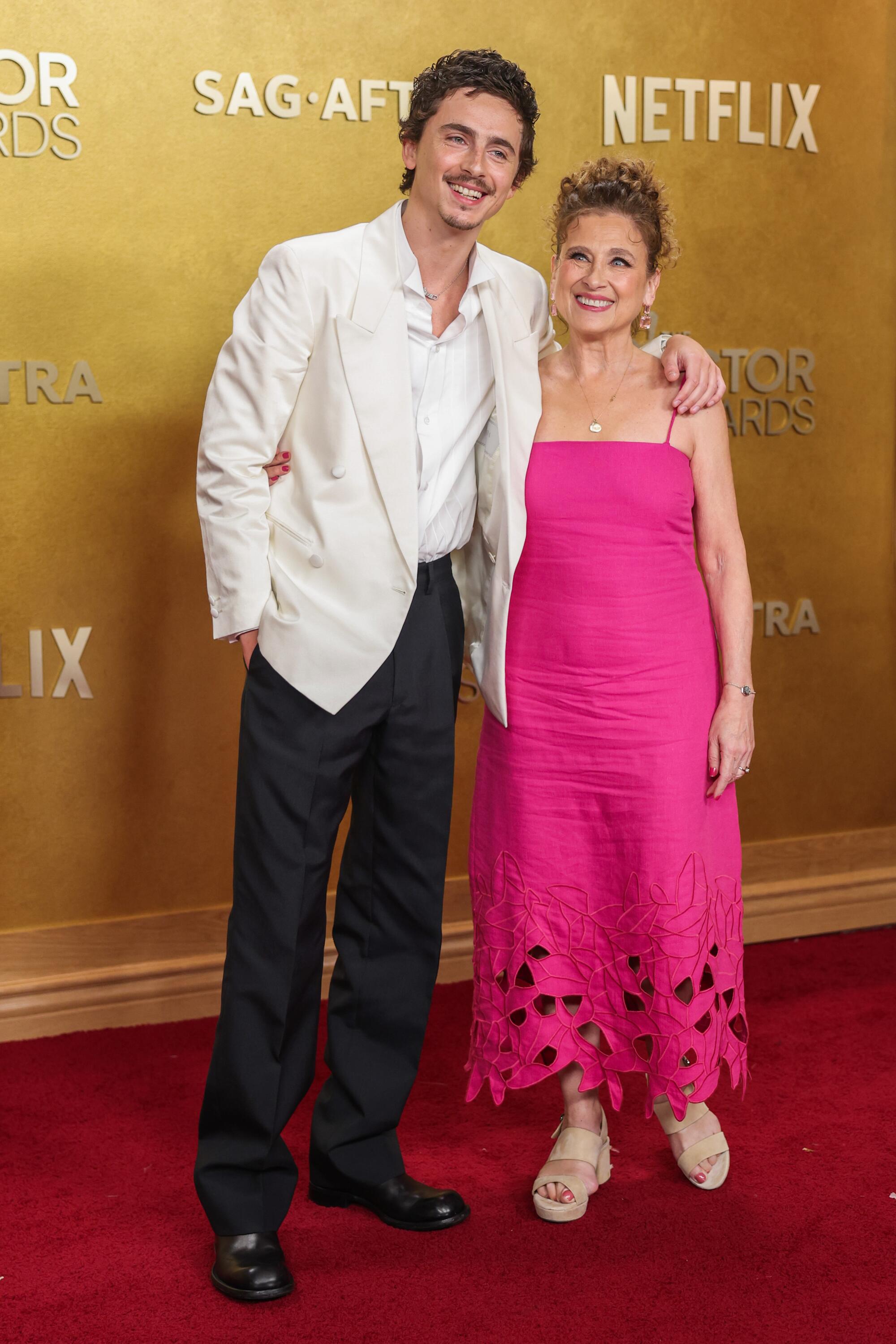 Timothée Chalamet and Nicole Flender pose on the red carpet. 