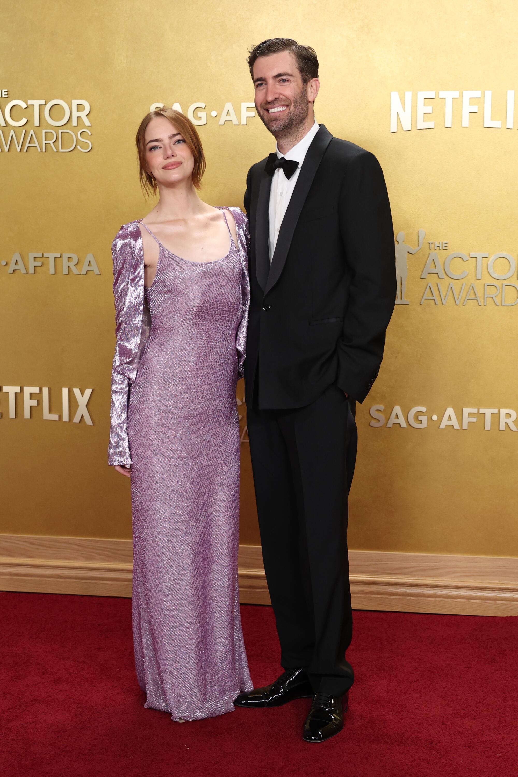 Emma Stone and Dave McCary pose on the red carpet. 