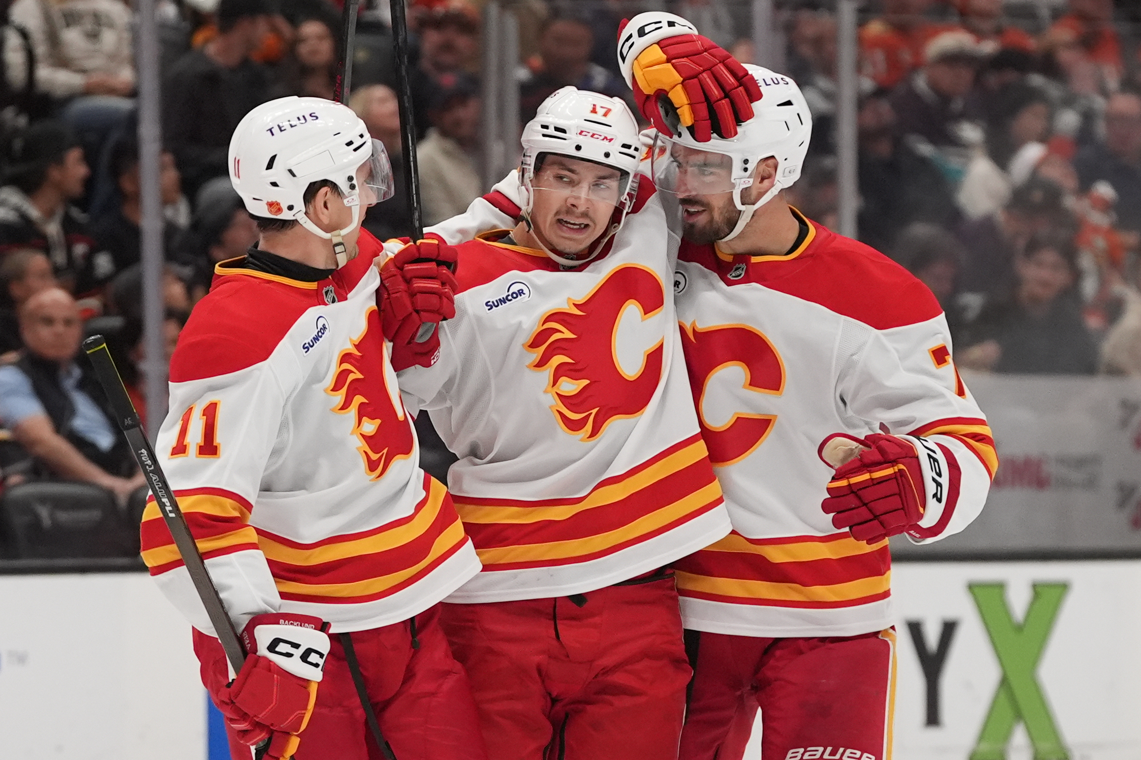 Calgary Flames center Yegor Sharangovich, center, celebrates his goal with...
