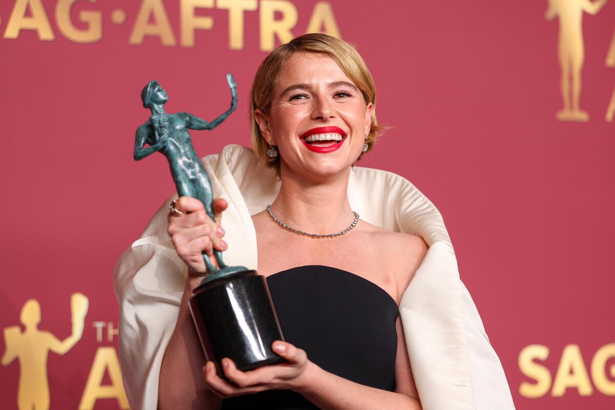 Jessie Buckley poses with the award for Outstanding Performance by a Female Actor in a Leading Role for "Hamnet."