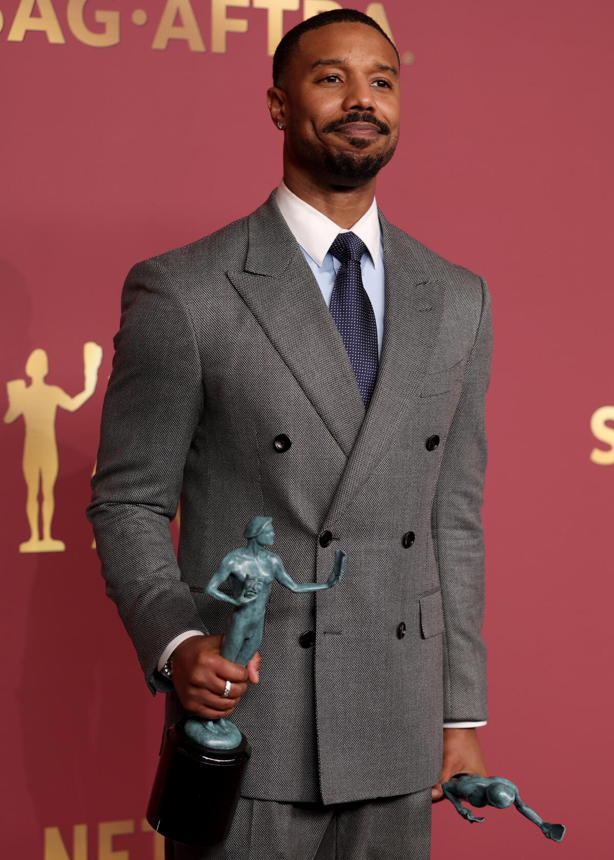 Michael B. Jordan holds his Actor Award for Outstanding Performance by a Male Actor.