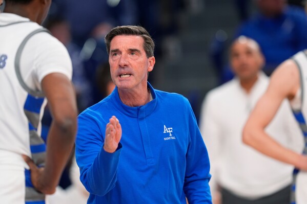 Air Force head coach Joe Scott confers with Air Force guard Byron Brown (11) in the first half of an NCAA college basketball game, on Feb. 6, 2024, at Air Force Academy, Colo. (AP Photo/David Zalubowski, File)