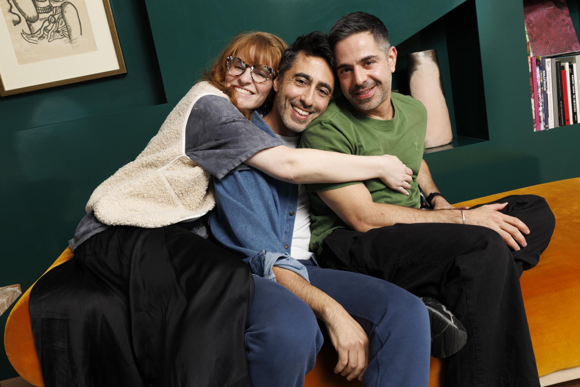 Three friends sit side by side.