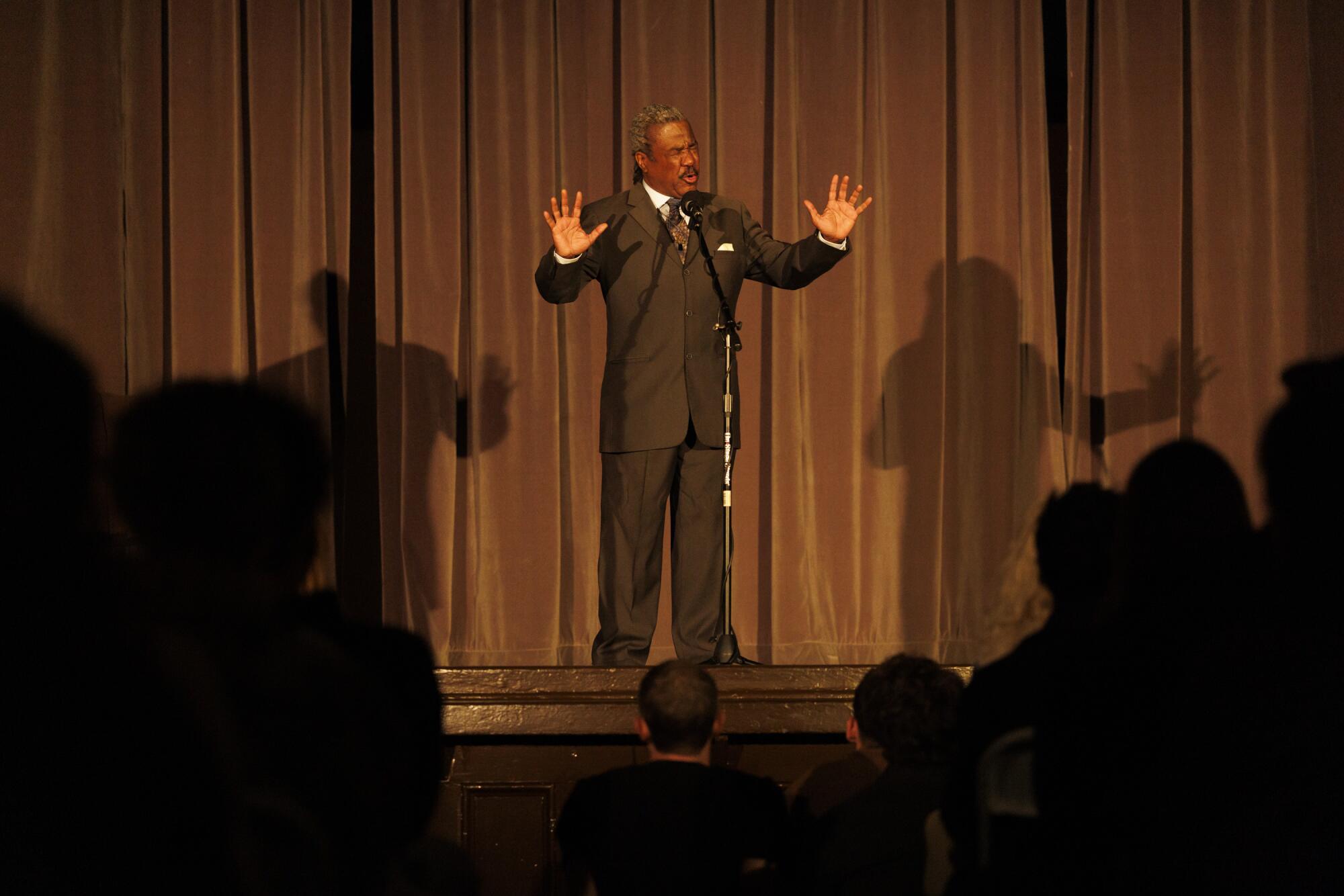 A man performs a speech onstage