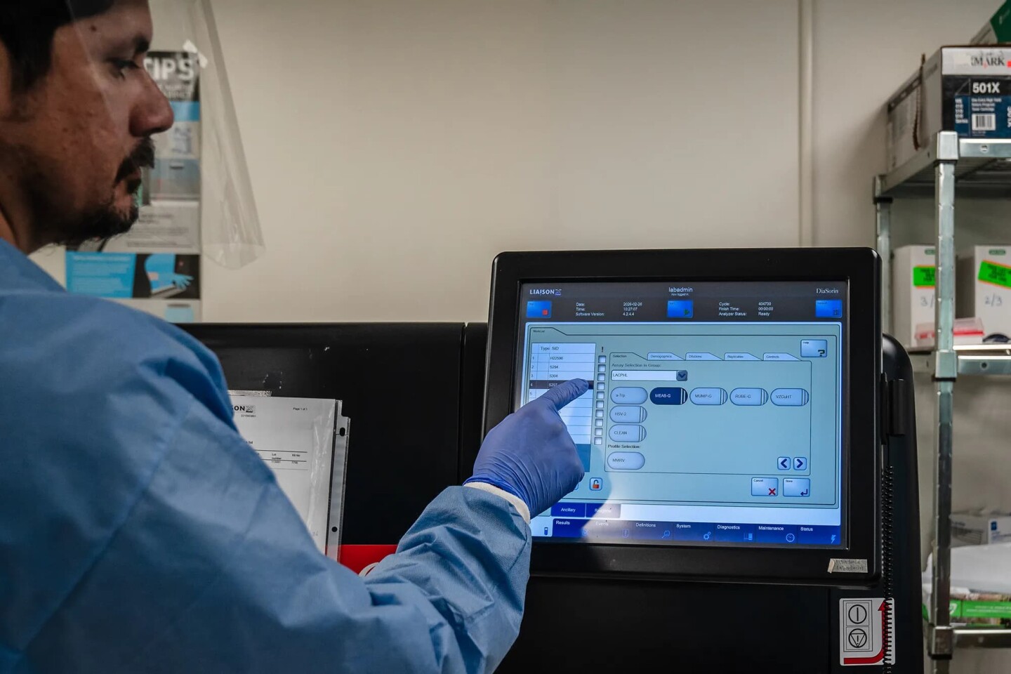 Lab Assistant Abraham Jimenez loads blood samples for automated serology testing for measles immunity status at the Los Angeles County Department of Public Health laboratory in Downey on Feb. 26, 2026.