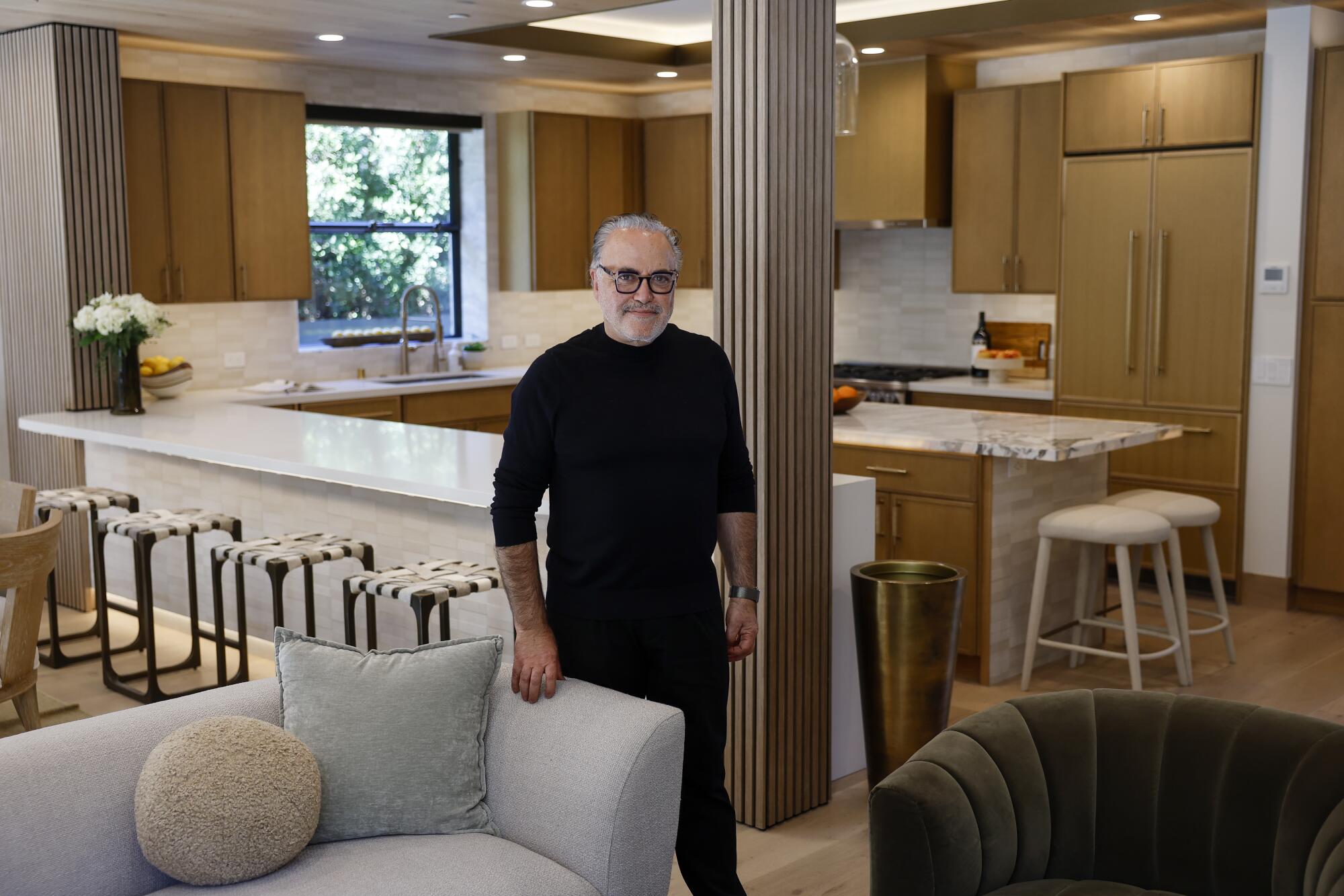 Ardie Tavangarian stands inside a house.