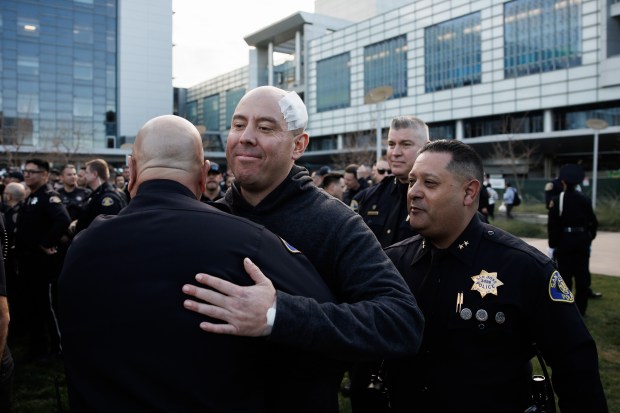 San Jose police sergeant Gerardo Silva, center, who has been with the department for 13 years, was released from the hospital to a crowd of supporting fellow officers at Santa Clara Valley Medical Center on Thursday, Jan. 22, 2026. The sergeant suffered a gunshot wound to his head during a shootout with a man suspected in a robbery and carjacking spree over the past week.(Dai Sugano/ Bay Area News Group)