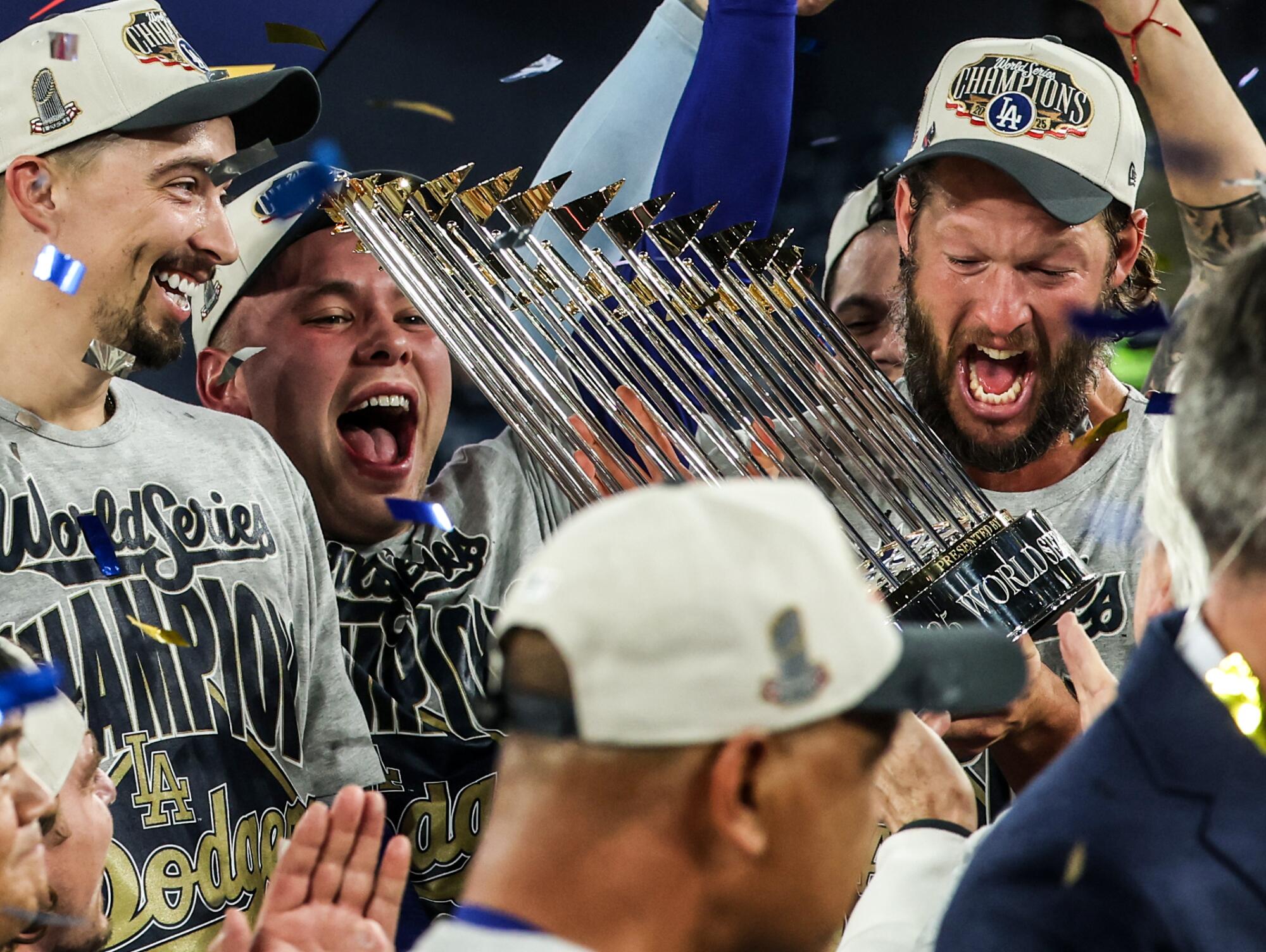 Dodgers pitcher Clayton Kershaw, right, celebrates with teammates after the Dodgers defeated the Toronto Blue Jays.
