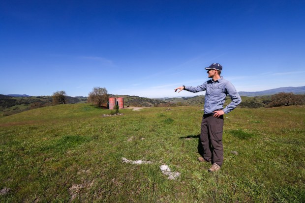 Gordon Clark, president of the Peninsula Open Space Trust, a nonprofit environmental group based in Palo Alto, points out various landmarks from a summit on Mead Ranch in Morgan Hill, Calif., on Friday, Feb. 27, 2026. The 1,921-acre property, located between San Jose and Morgan Hill and formerly owned by members of the Bechtel family, was sold to the nonprofit for $24.3 million. (Ray Chavez/Bay Area News Group)