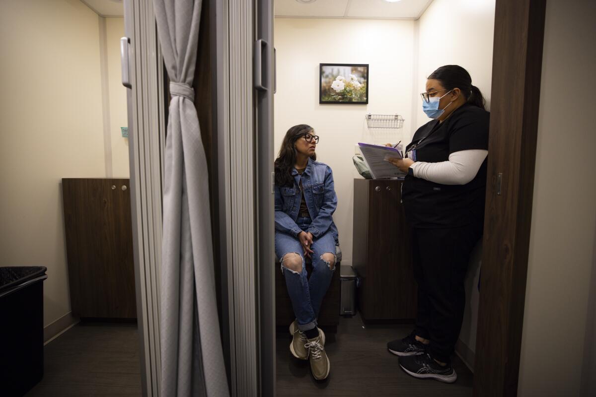 Naureen Sayani, 47, left, discusses her medical history with Adriana Galindo, a medical assistant, before getting mammogram
