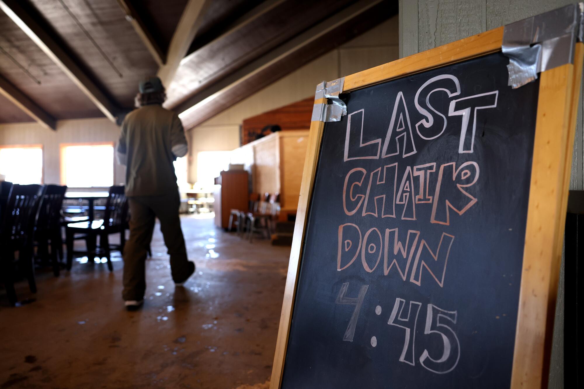 A sign inside Top of the Notch restaurant at Mt. Baldy reads, "Last Chair Down 4:45."