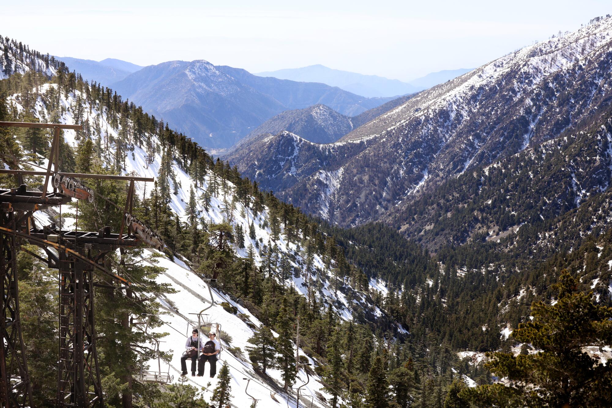 Michael Phelps, left, and Seven Foster, of Riverside, take the chairlift up to Mt. Baldy Resort.