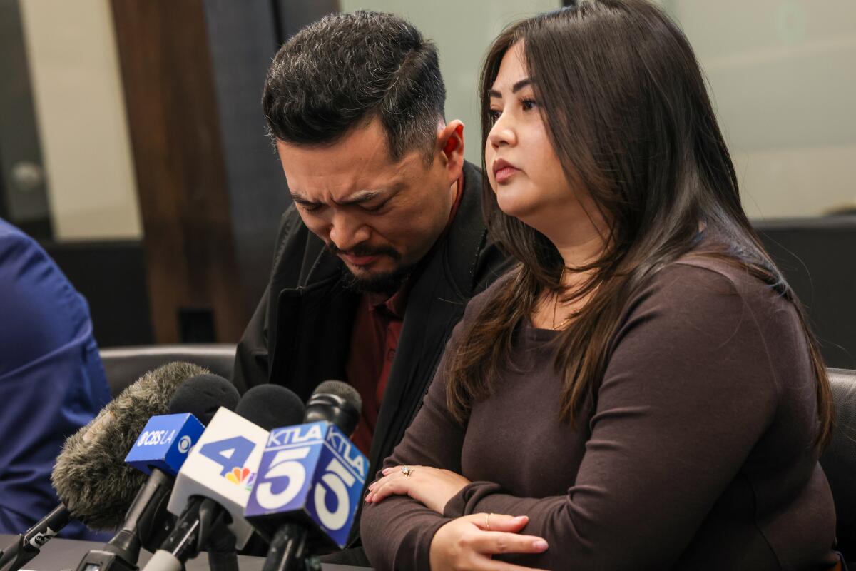 Monique and Allen Santos field questions from media members during a press conference