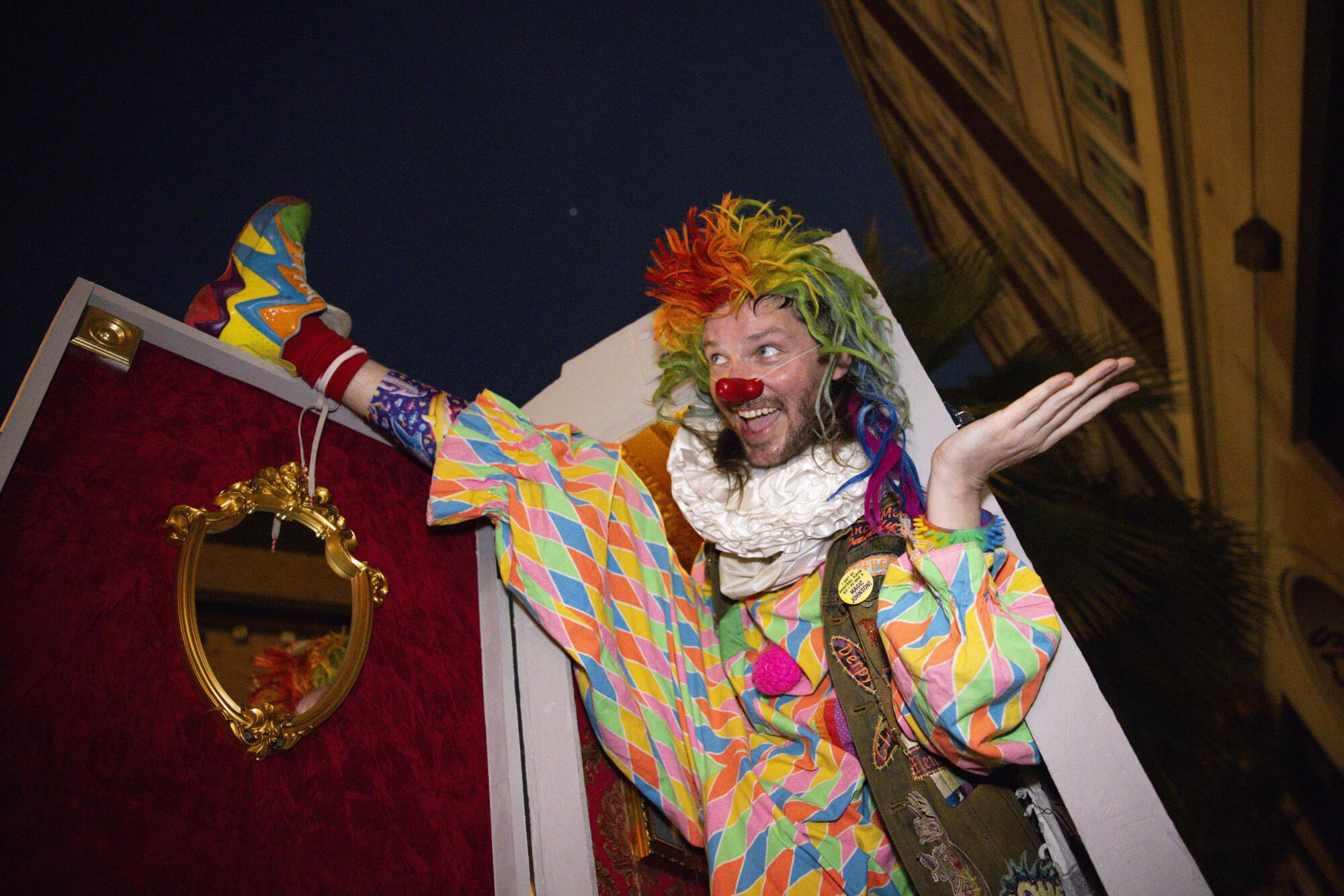 Clown, Lars Adams, 38, peers out of S.C. Mero's theater inside a fake electrical box. 