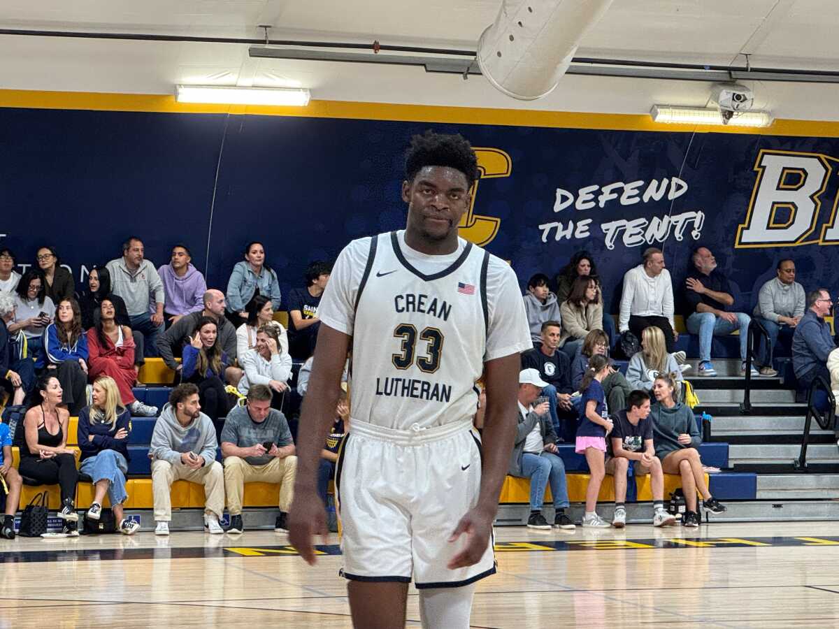 Chadrack Mpoyi walks off the basketball court during a Crean Lutheran game.