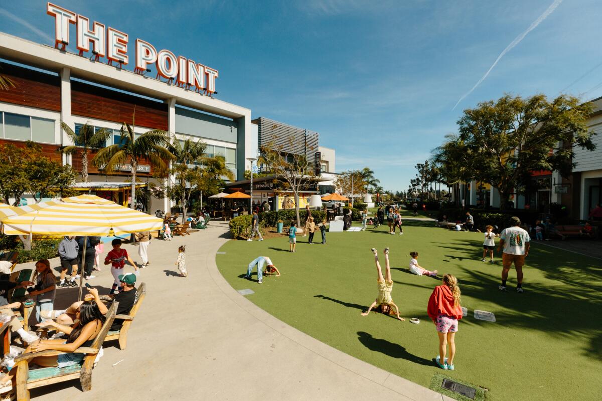 Families enjoy the lawn at a shopping mall