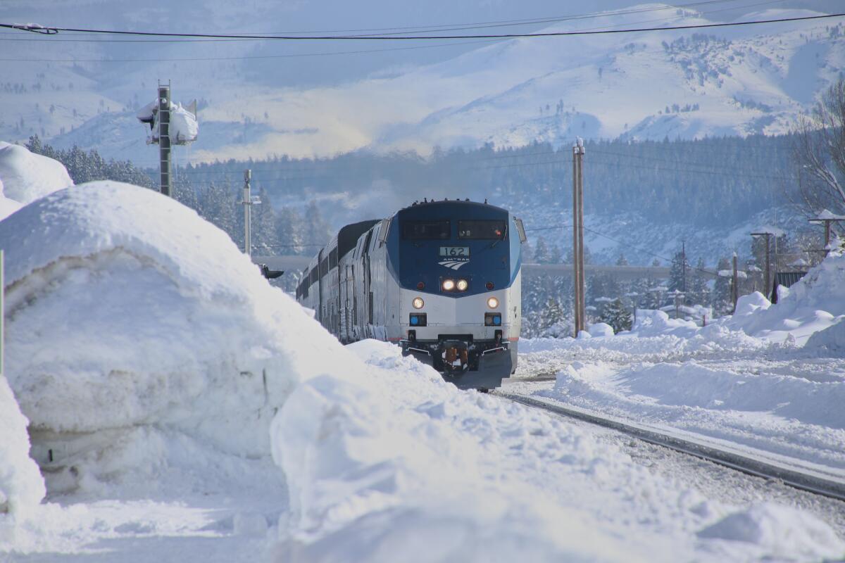 An Amtrak train passing through Truckee, Calif. is surrounded by snow.