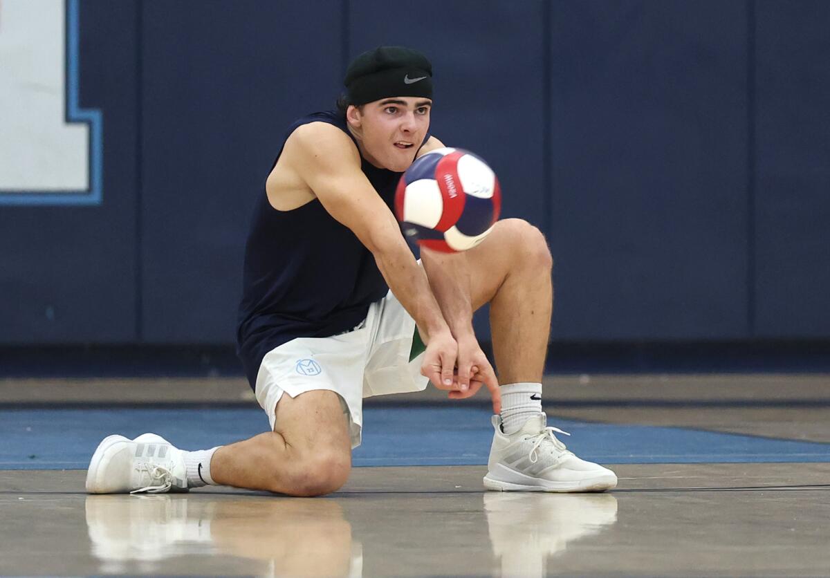 Corona del Mar's Chapman Warmington (2) digs a ball in the back row against Huntington Beach.
