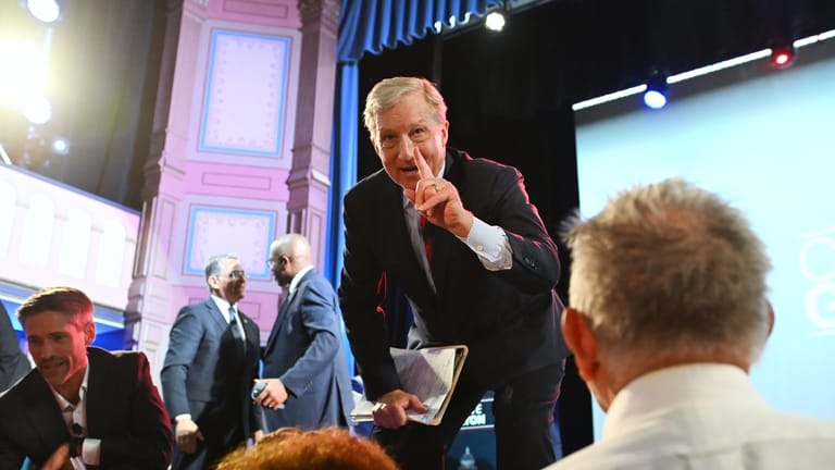 Tom Steyer, right, and Matt Mahan talk to attendees after...