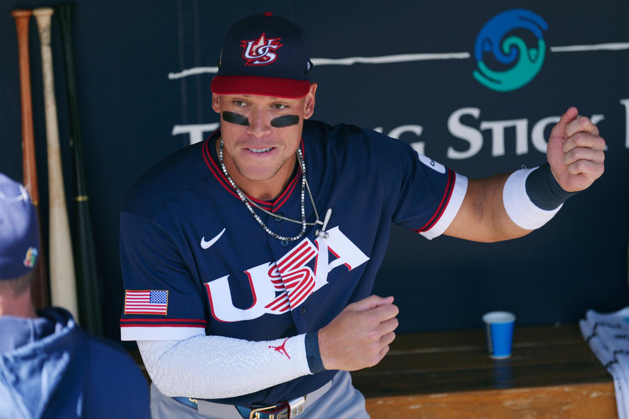 The United States' Aaron Judge talks with a coach prior to an exhibition game against the Colorado Rockies on Wednesday.