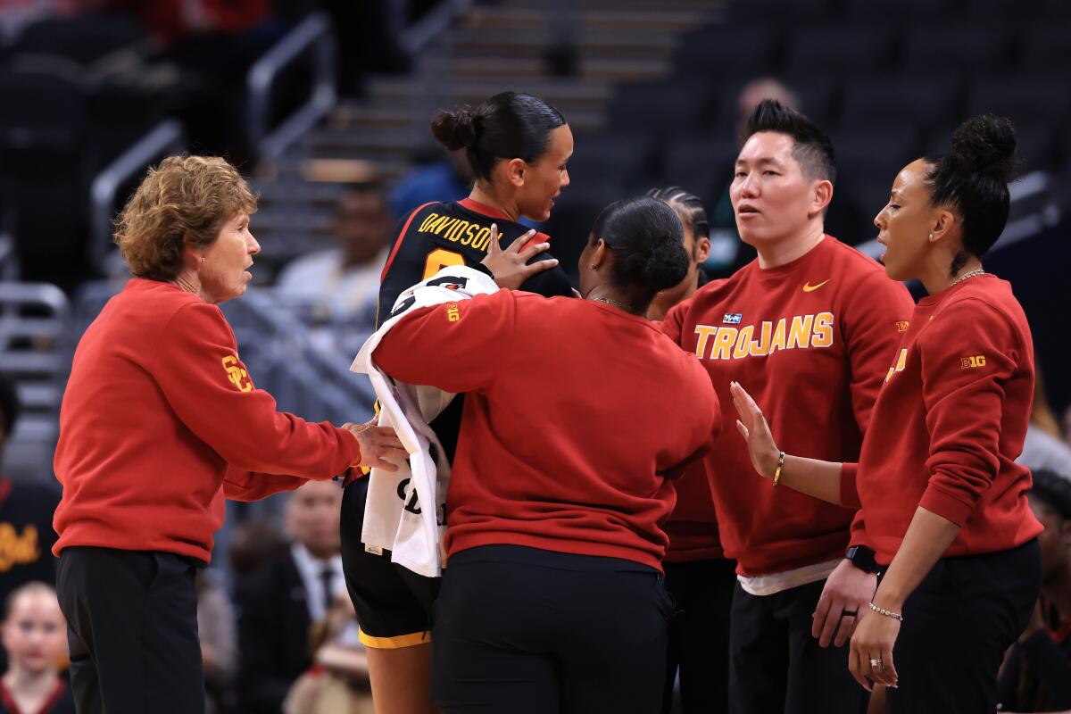 USC's Jazzy Davidson leaves the game after sustaining an injury against Washington on Thursday.