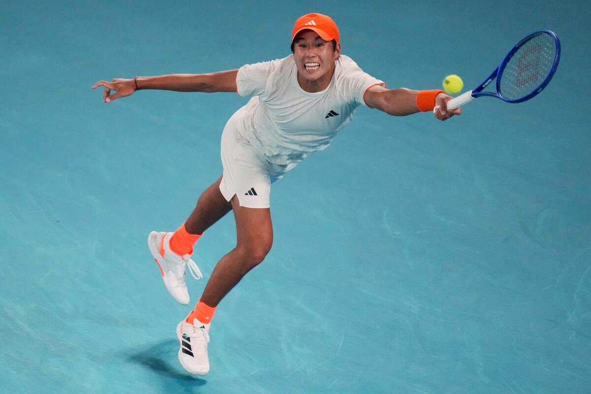 Learner Tien plays a forehand return to Alexander Zverev in the Australian Open quarterfinals on Jan. 27.