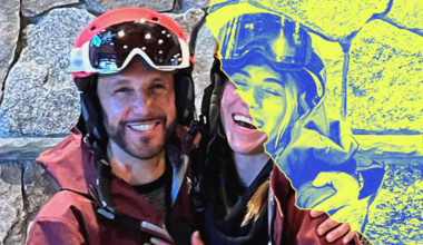 A smiling man and woman in ski gear hug in front of a stone wall, with the right half of the image showing a blue and yellow stylized filter.