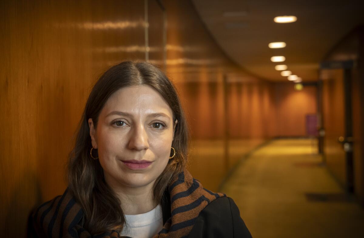 A woman in a hallway.