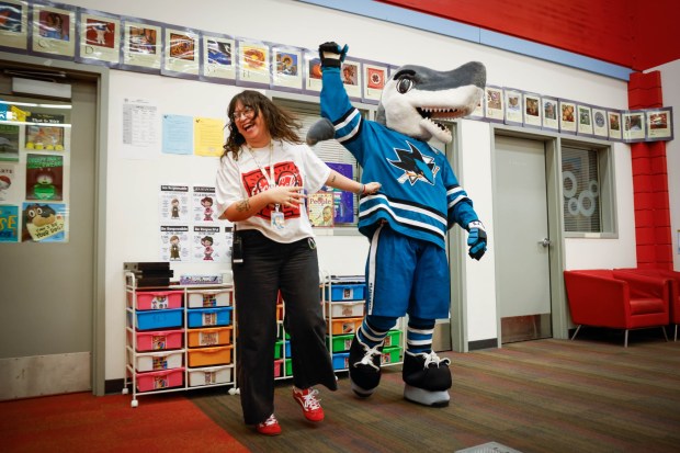 Victoria Lozano, family liaison at Bachrodt Elementary, dances with S.J. Sharkie during a literacy event called Reading is Cool by the Sharks Foundation at Bachrodt Elementary in San Jose, Calif., on Thursday, March 5, 2026. (Shae Hammond/Bay Area News Group)