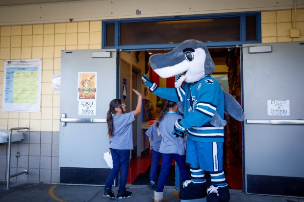 San Jose Sharks' S.J. Sharkie high fives students at Bachrodt Elementary in San Jose, Calif., on Thursday, March 5, 2026. (Shae Hammond/Bay Area News Group)