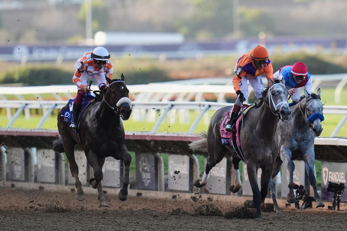 John Velazquez rides Ted Noffey, center, to victory past Flavien Prat aboard Brant, right, and Antonio Fresu on Mr. A.P.