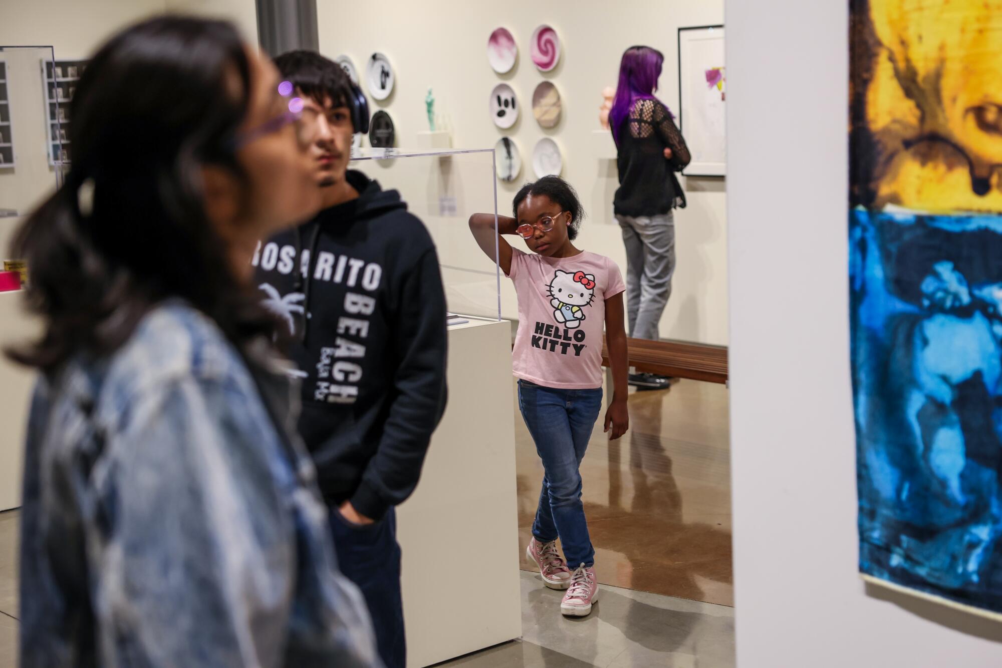 Fourth grader Honey Cooper views an art exhibit with other students in a design class