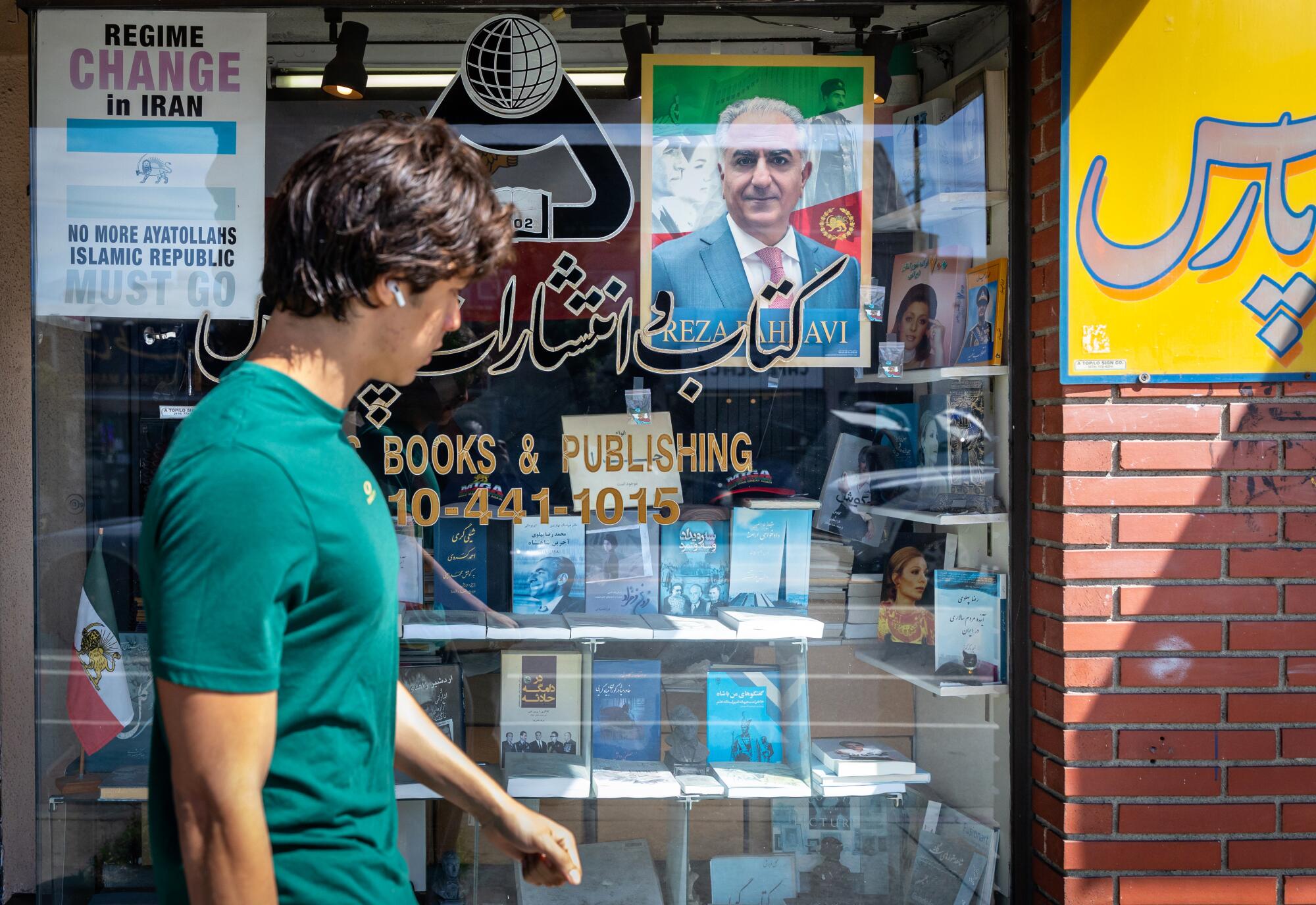 Regine Change in Iran signs and photos of Pahlavi, the exiled son of Iran's last shah, can be seen in lots of shop windows