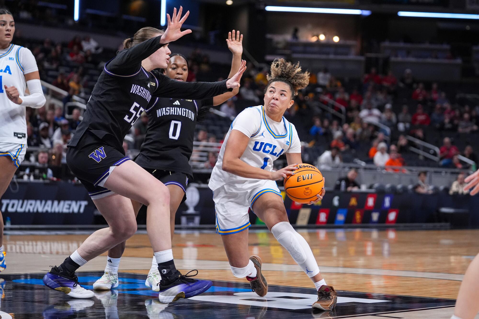 UCLA guard Kiki Rice drives under Washington center Yulia Grabovskaia during the Big Ten tournament Friday.