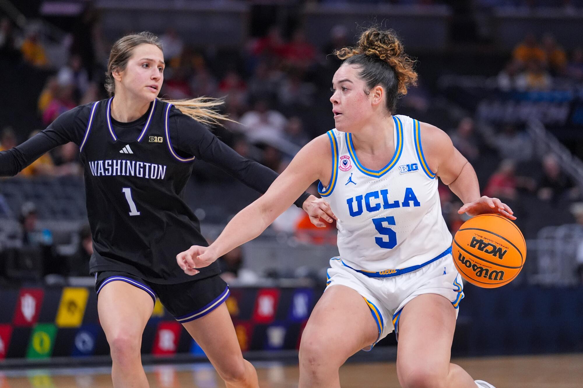 UCLA guard Charlisse Leger-Walker drives under pressure from Washington guard Hannah Stines on Friday.