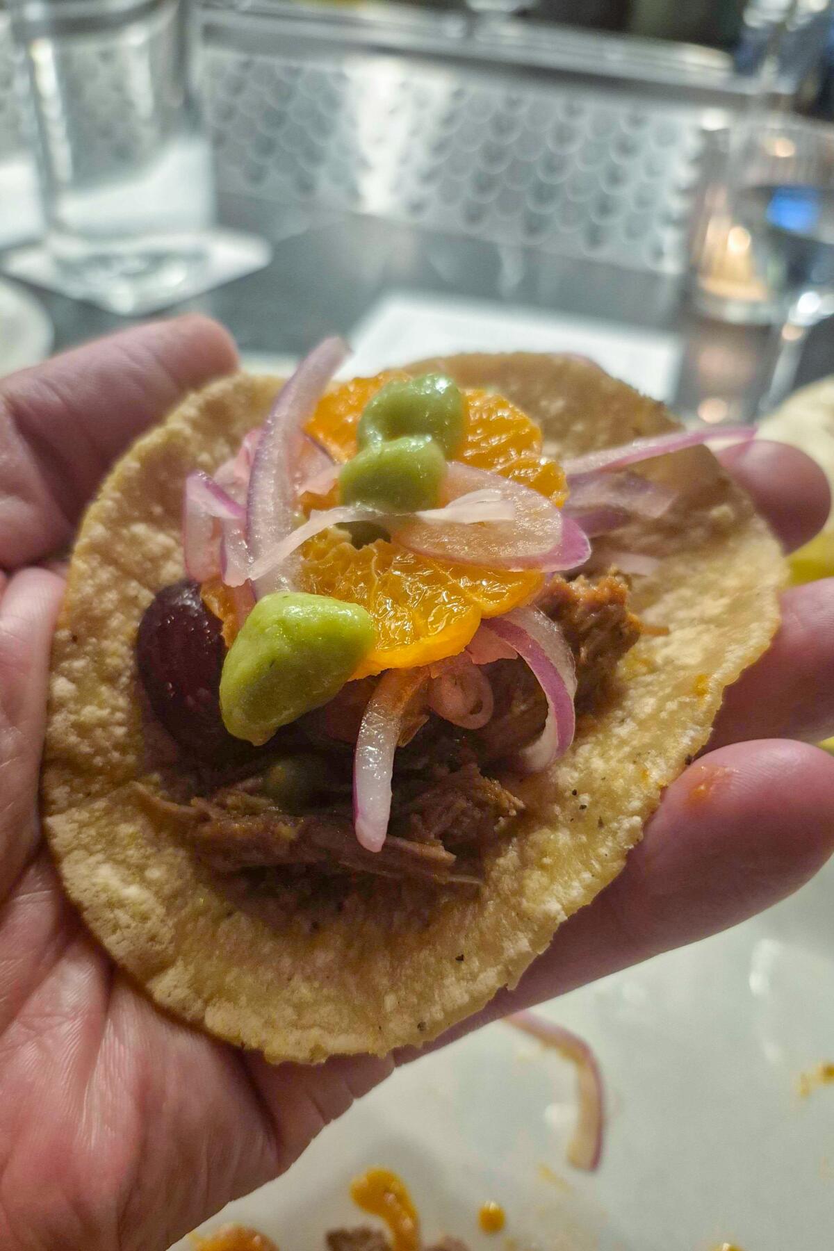 A taco composed of the Masala y Maíz lamb barbacoa main dish. The tortillas employed masa from L.A. molino Komal.