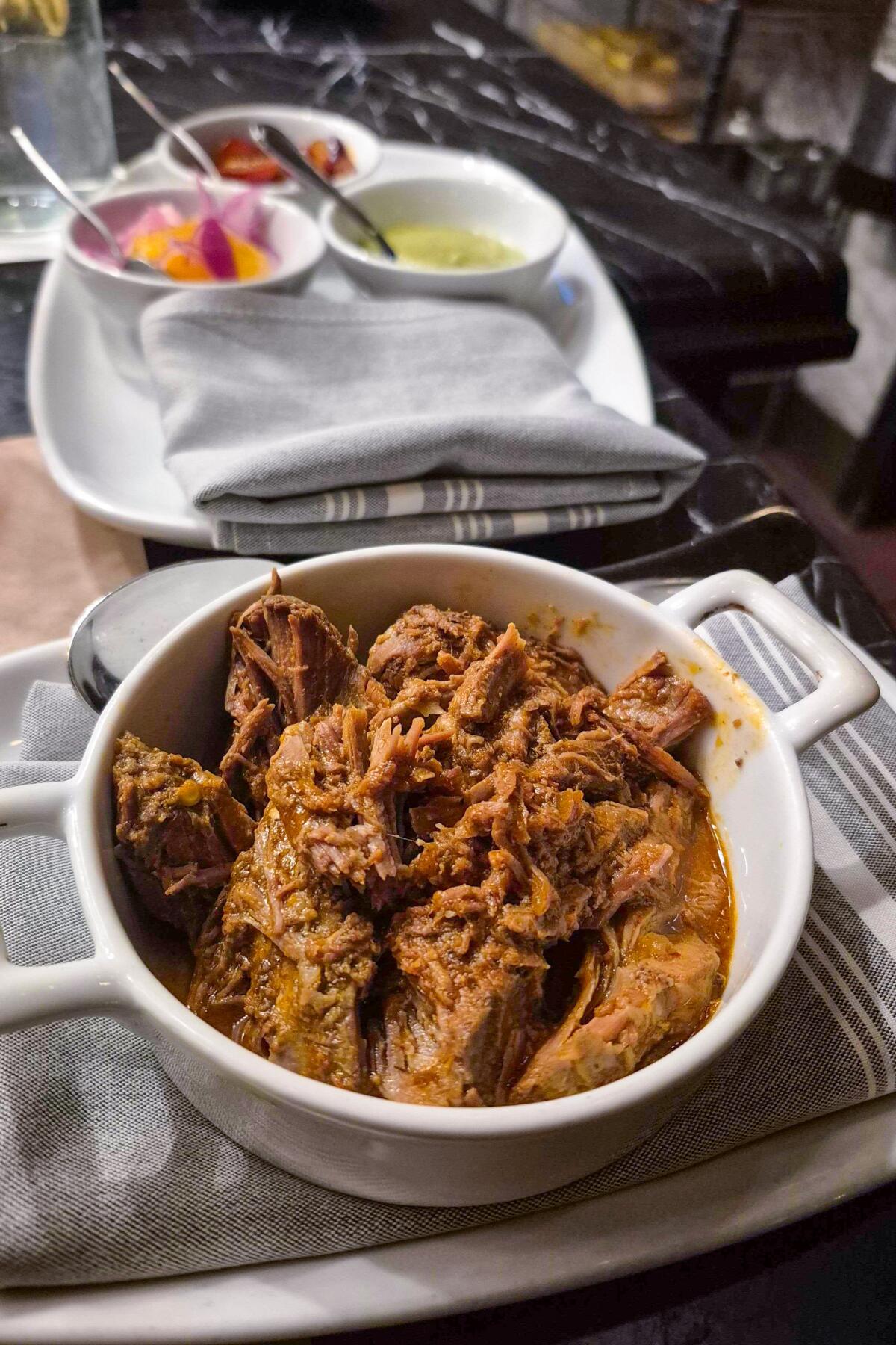 The lamb barbacoa came with a consomme, biryani tamal, kachumbari, salsa verde and grape achaar.