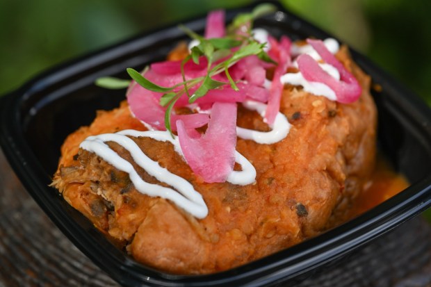 Torta Ahogada; braised pork carnitas, frijoles charros, pickled onion and salsa at Mercado de Antojos festival marketplace food booth during the California Food & Wine Festival inside California Adventure running March 6 through April 27, 2026. Photographed on Friday, March 6, 2026. (Photo by Jeff Gritchen, Orange County Register/SCNG)