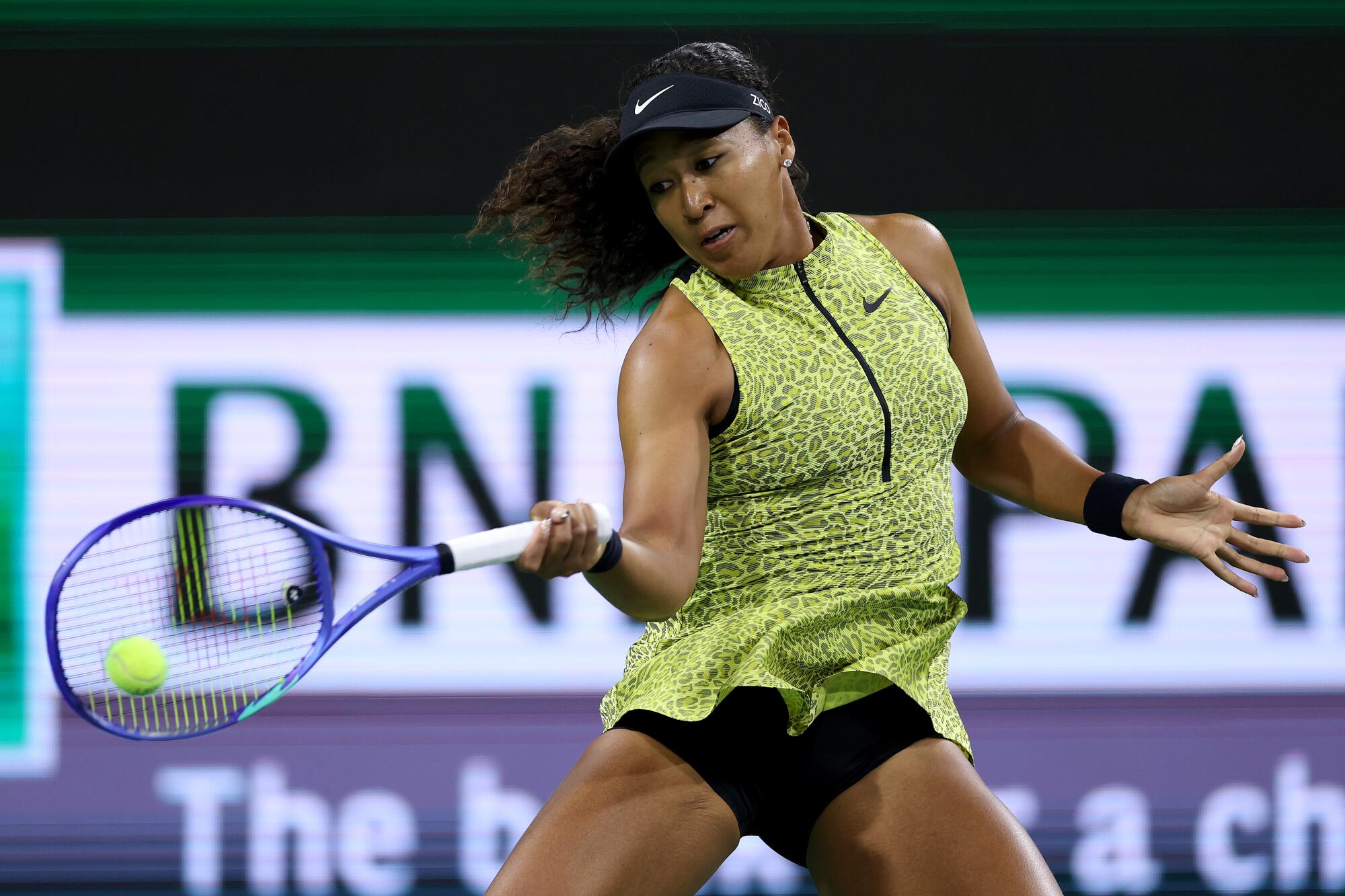 Naomi Osaka returns a shot to Victoria Jimenez Kasintseva during the BNP Paribas Open at Indian Wells.