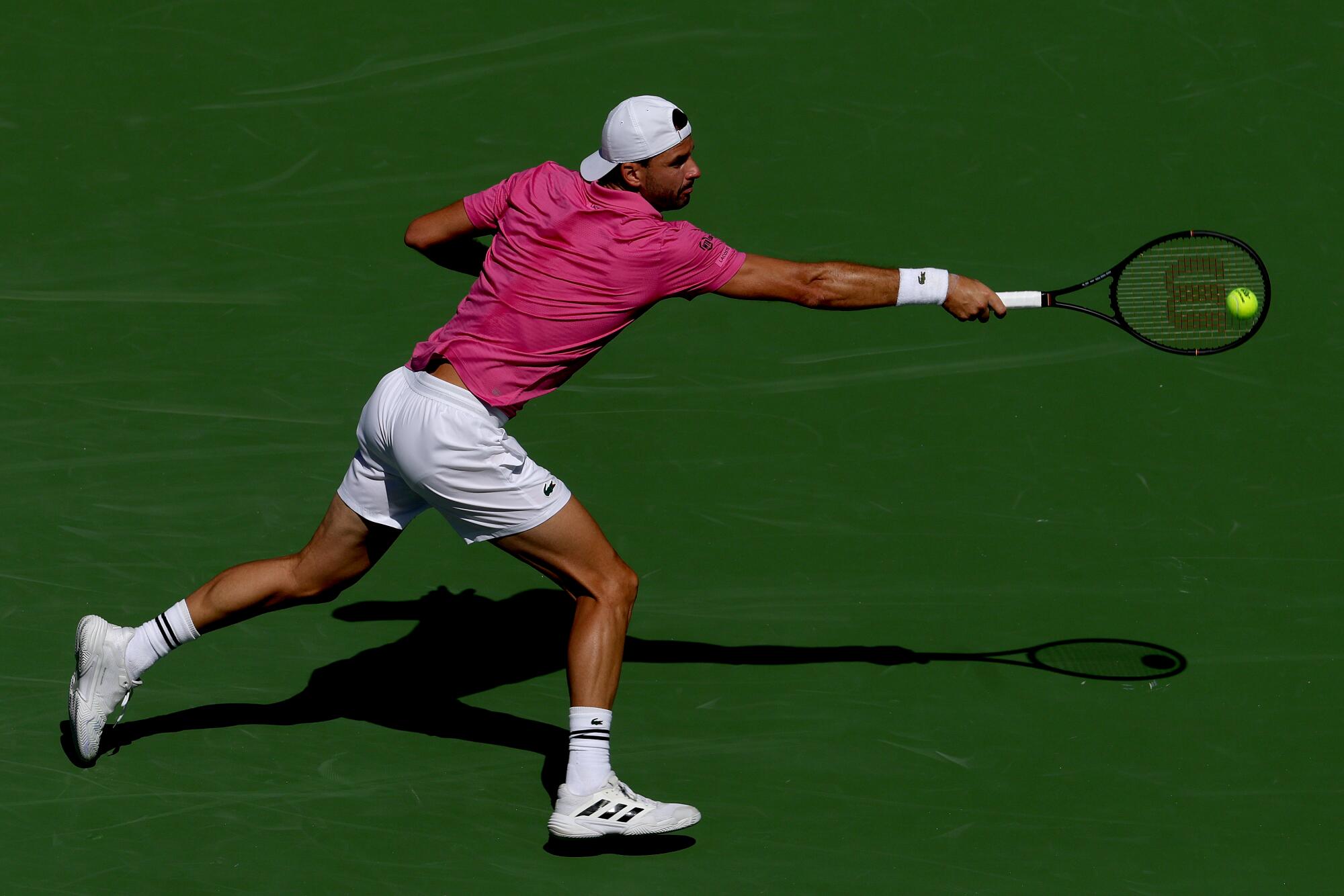 Grigor Dimitrov returns a shot to Terence Atmane during the BNP Paribas Open at the Indian Wells Tennis Garden.