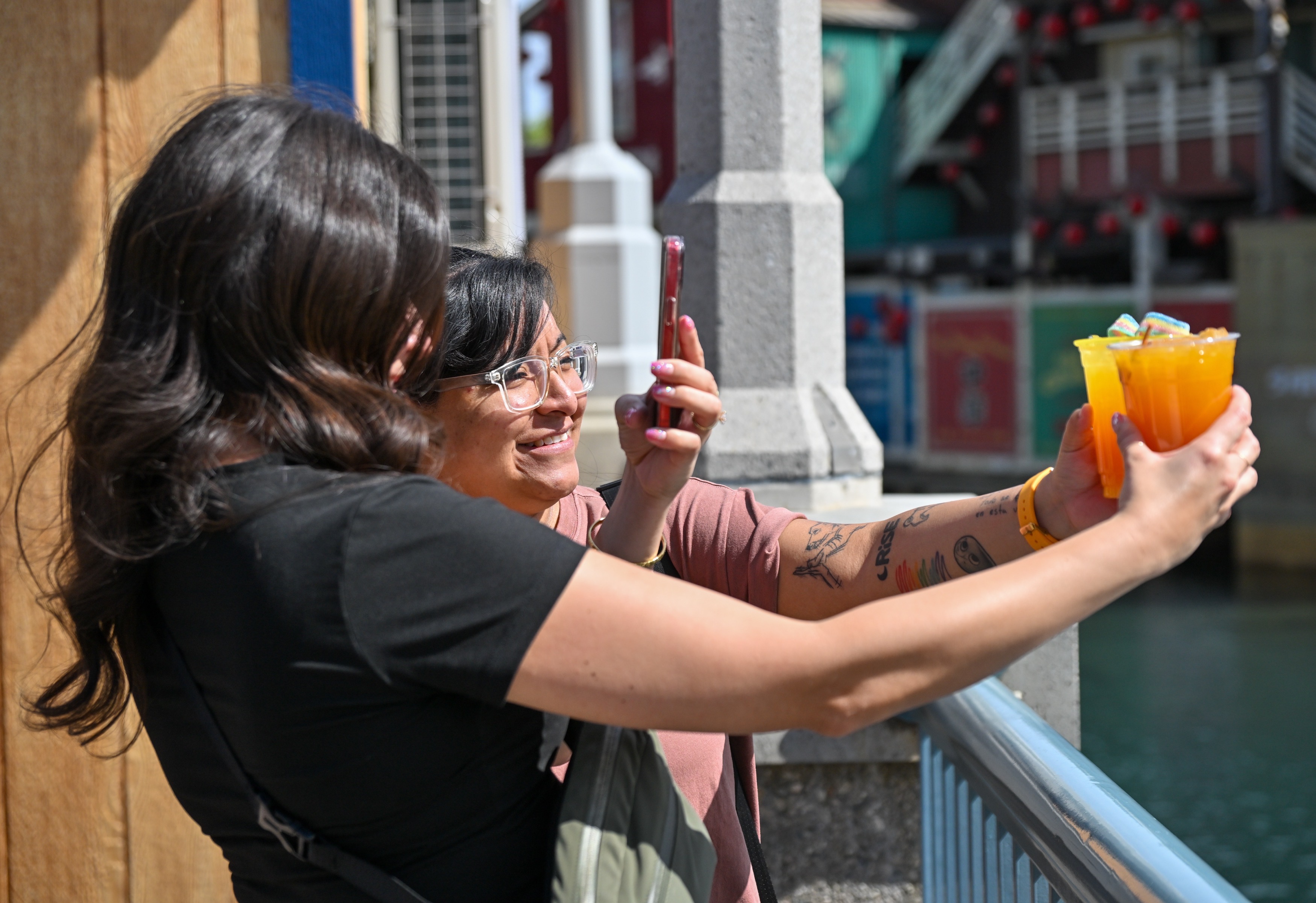 Kassandra Blancarte and Alejandra Forsberg take pictures of their drinks...