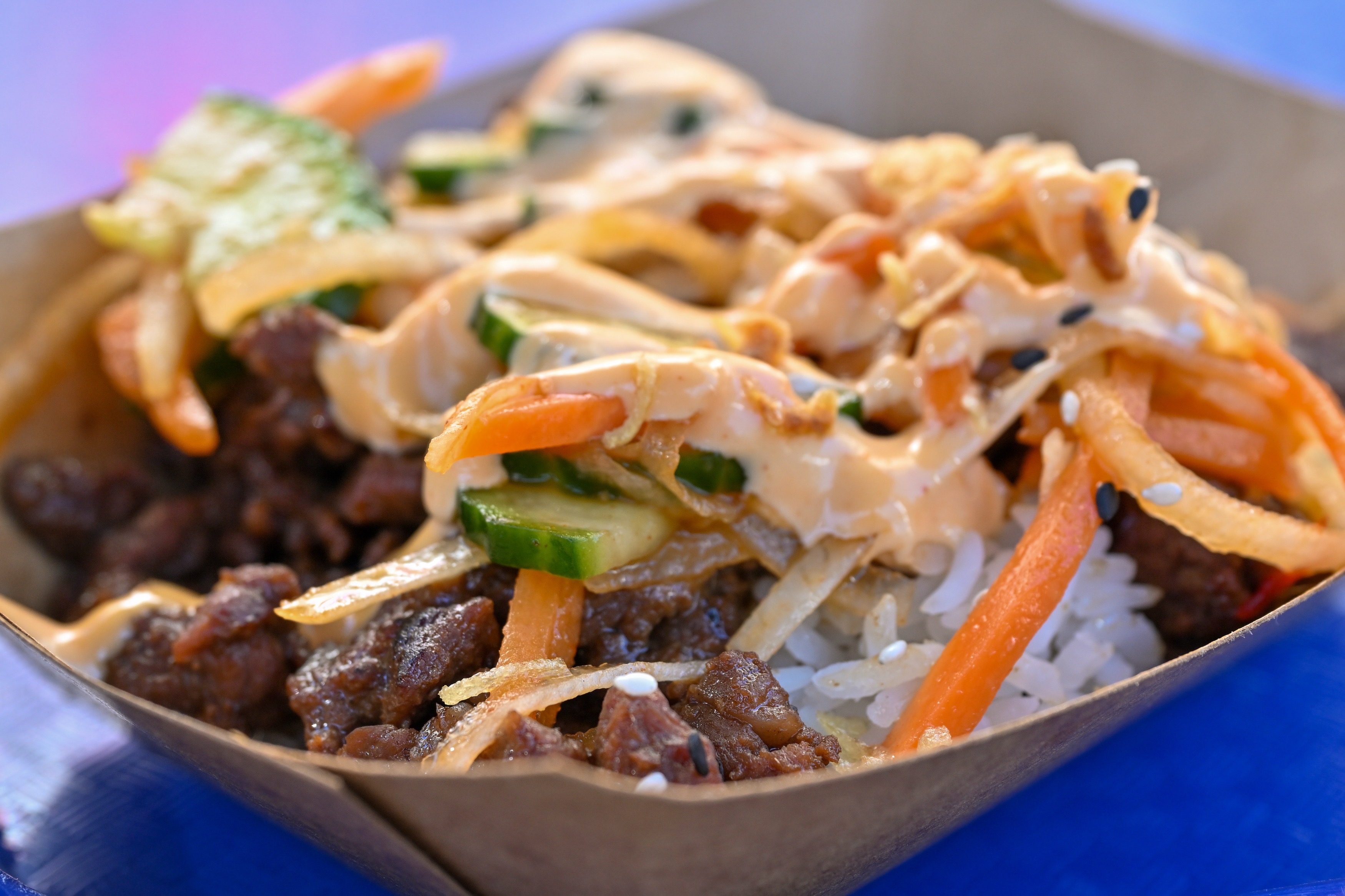 Bulgogi Bowl; Bulgogi beef and gochugaru-marinated cucumbers over rice garnished...