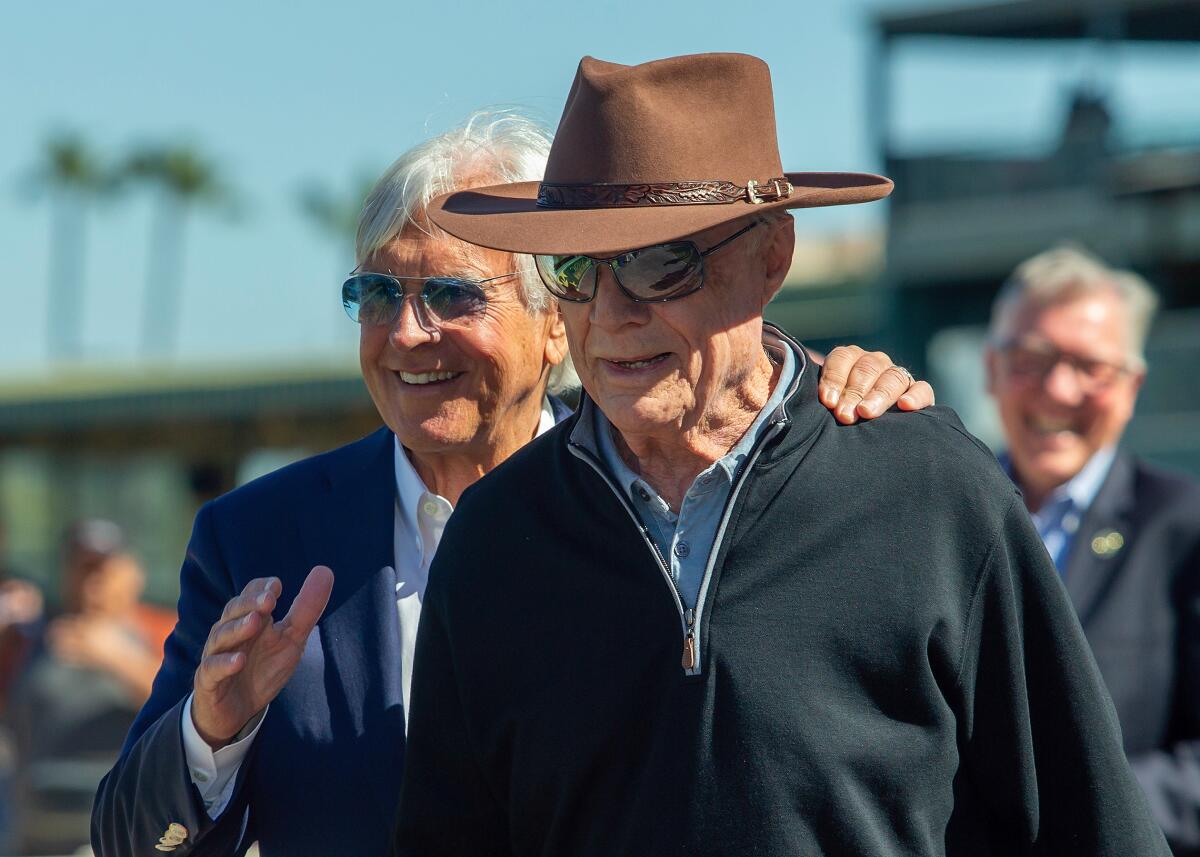 Co-owner David Michael Talla, right, and trainer Bob Baffert savor Splendora's victory in the B. Wayne Hughes Beholder Mile.