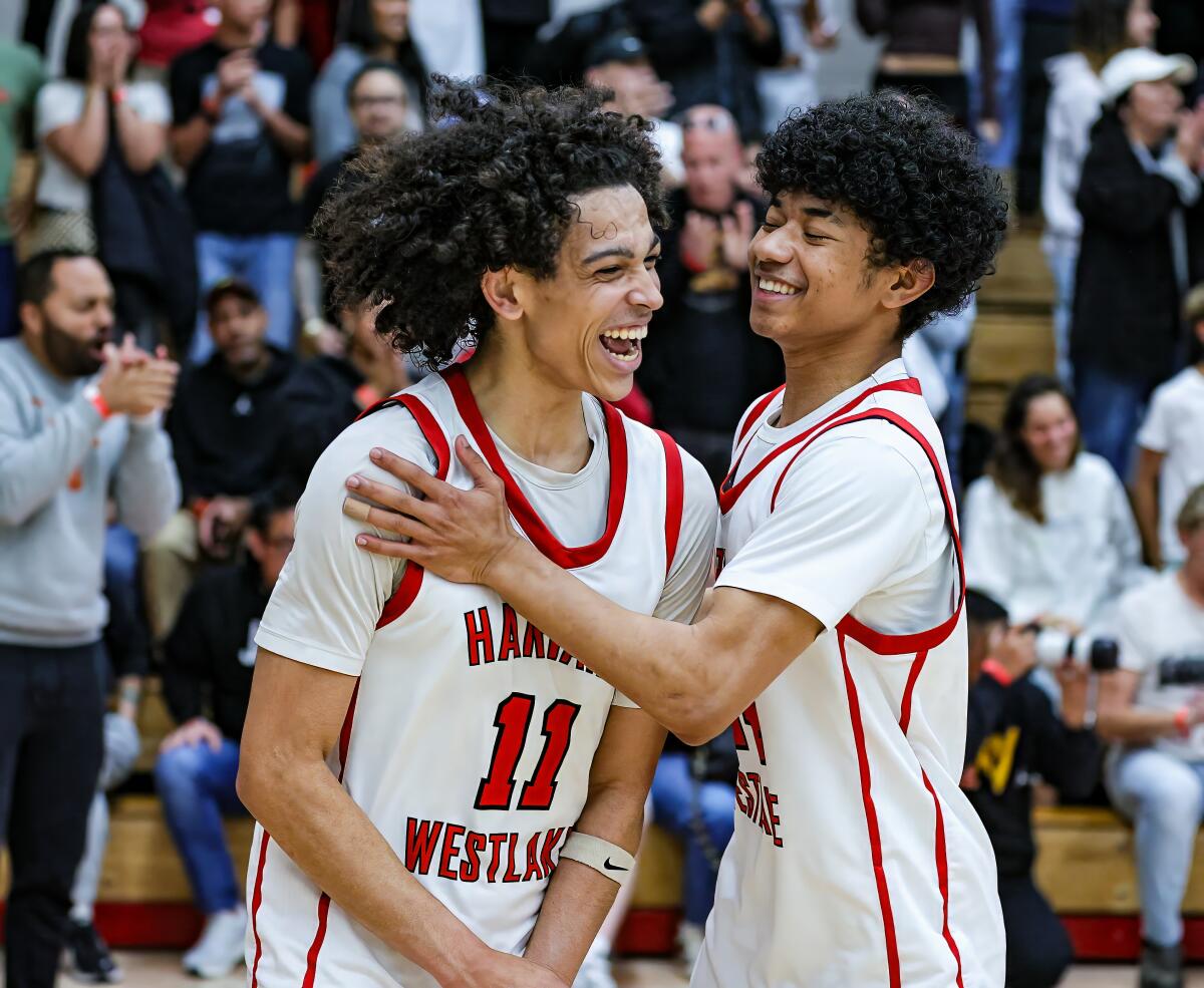 Pierce Thompson (left) gets congratulations from Miles Dodson after Harvard-Westlake 56-52 win over St. Joseph.
