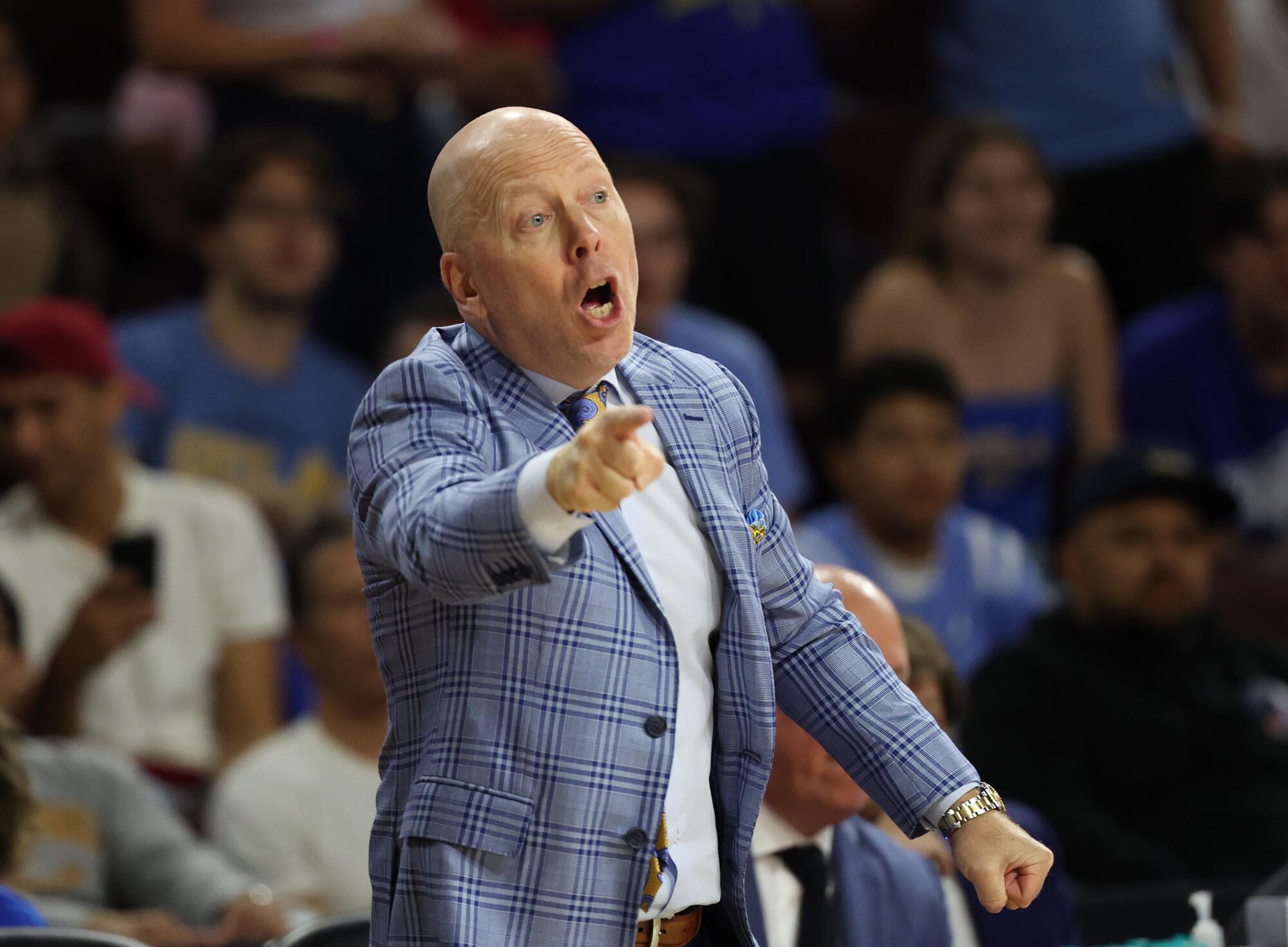 UCLA coach Mick Cronin shouts instructions to a player during the Bruins' win over USC on Saturday.
