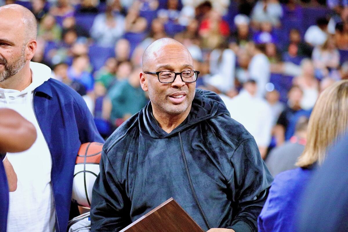 Sierra Canyon boys coach Andre Chevalier holds Southern Section Open Division plaque after win over Harvard-Westlake.