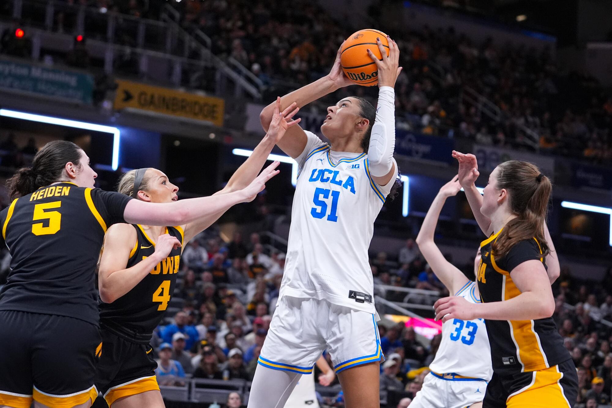 UCLA center Lauren Betts shoots over Iowa guard Kylie Feuerbach during Big Ten tournament title game Sunday.