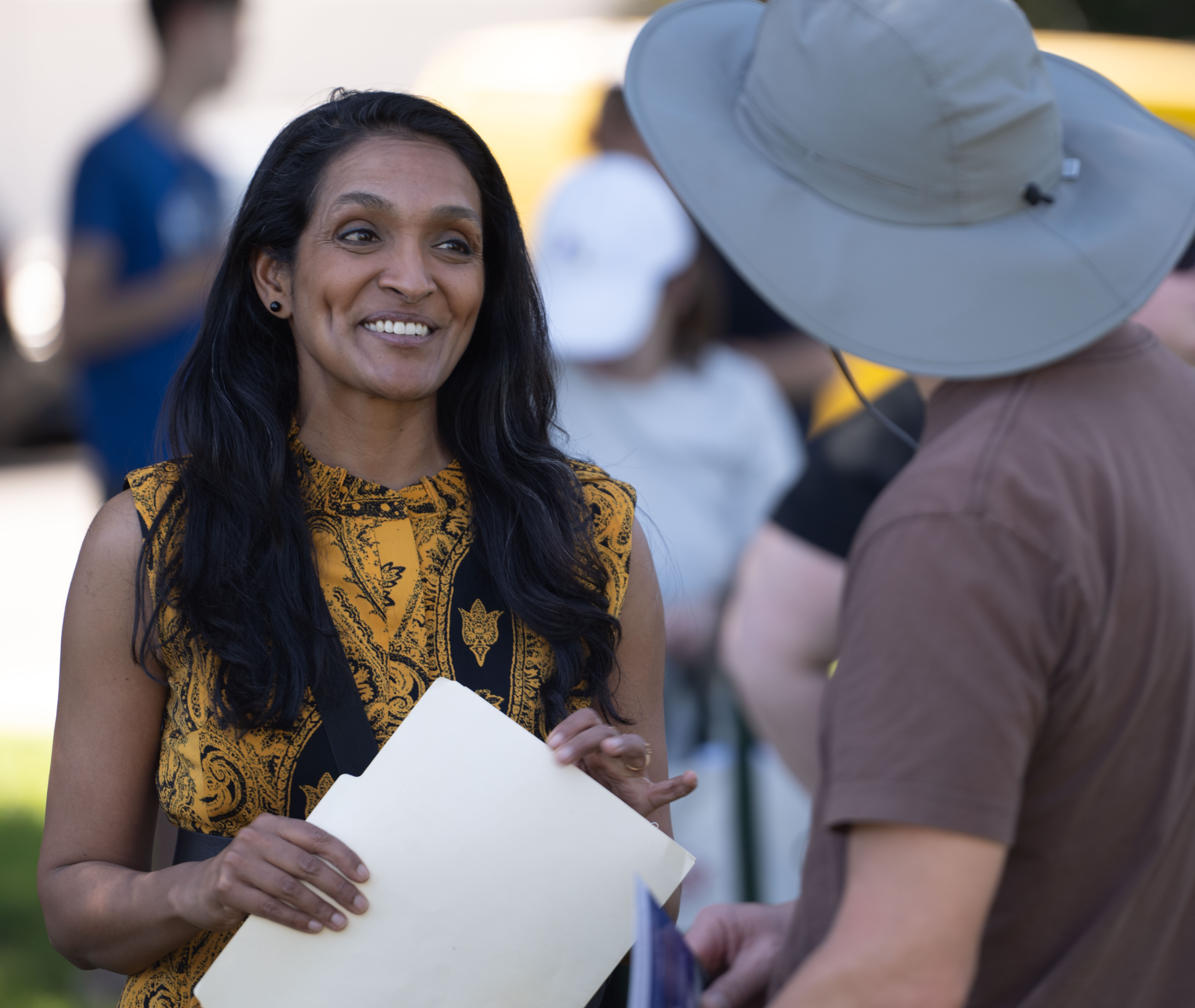 City Councilwoman Nithya Raman speaks with an attendee of her...