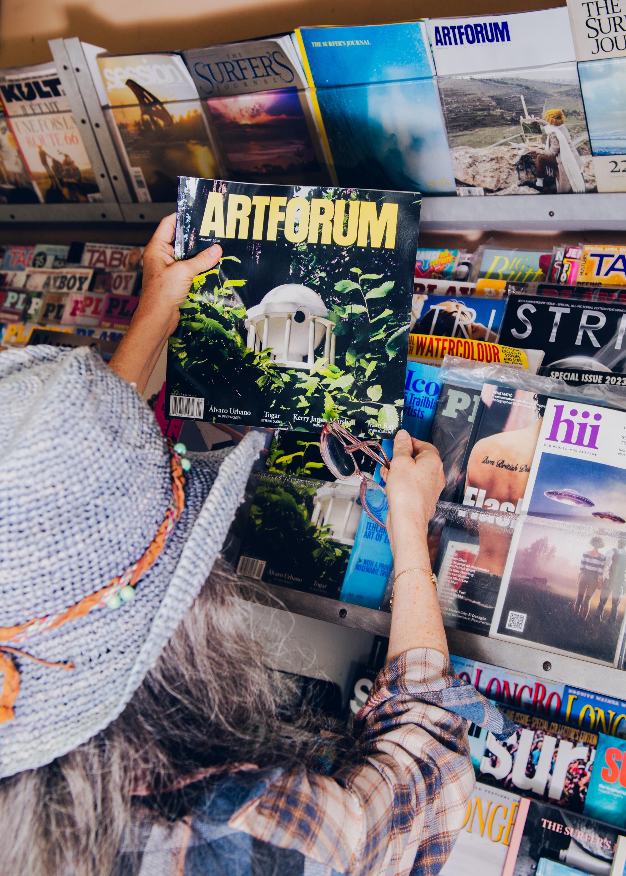 Malibu Newsstand. A customer looks at magazines.