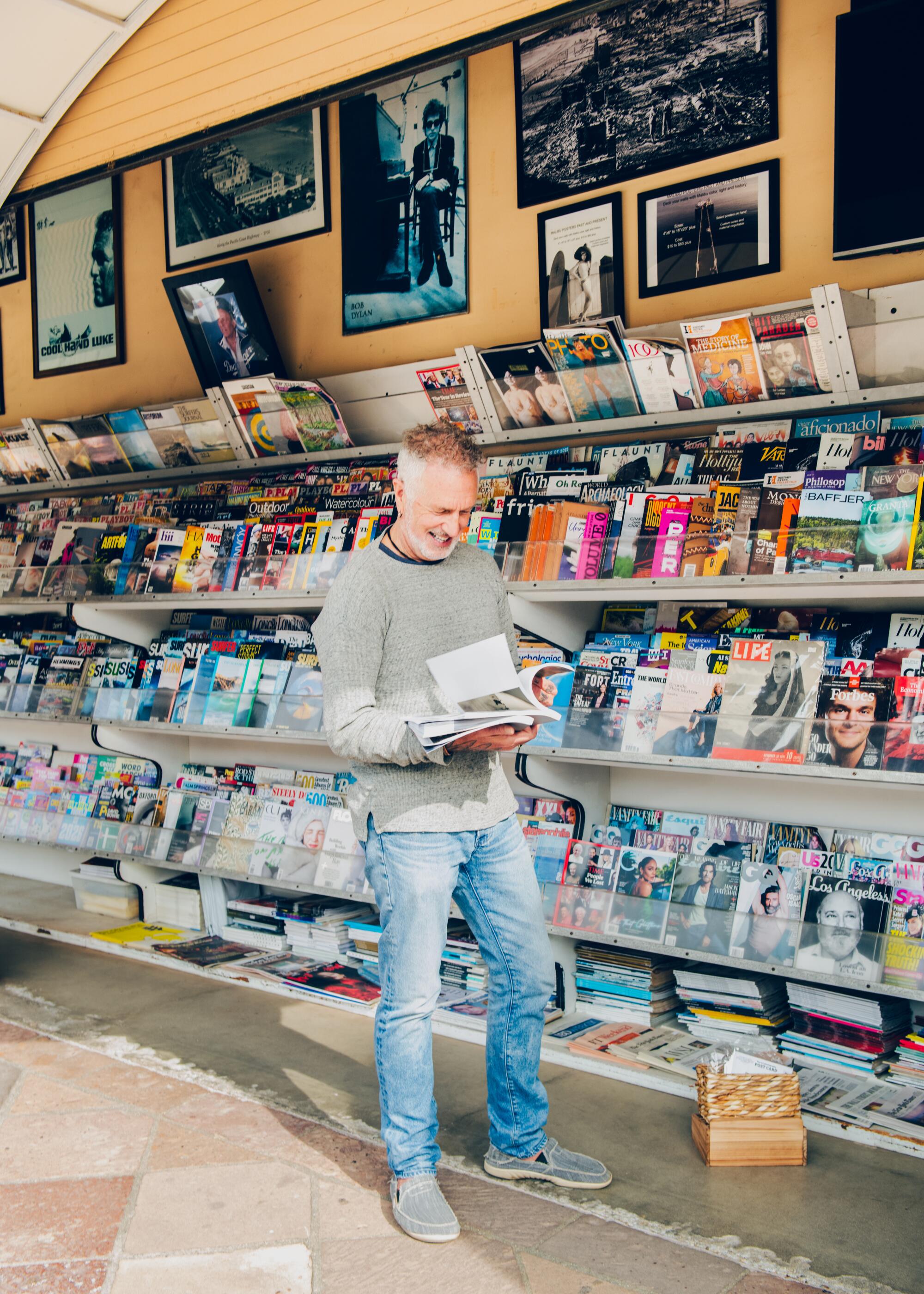 A customer named Jason, looks through magazines at the Malibu Newsstand.